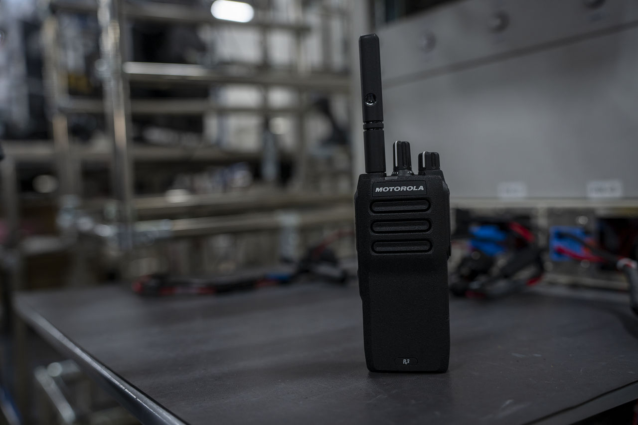 top features of modern two-way radios. Motorola solutions two-way radio standing on surface
