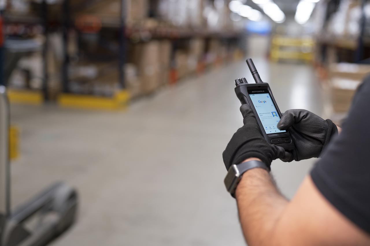 Guide to two-way radios. Hand holding motorola solutions ion radio.